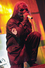 Photo of Corey Taylor in his Vol 3 outfit, singing into a microphone